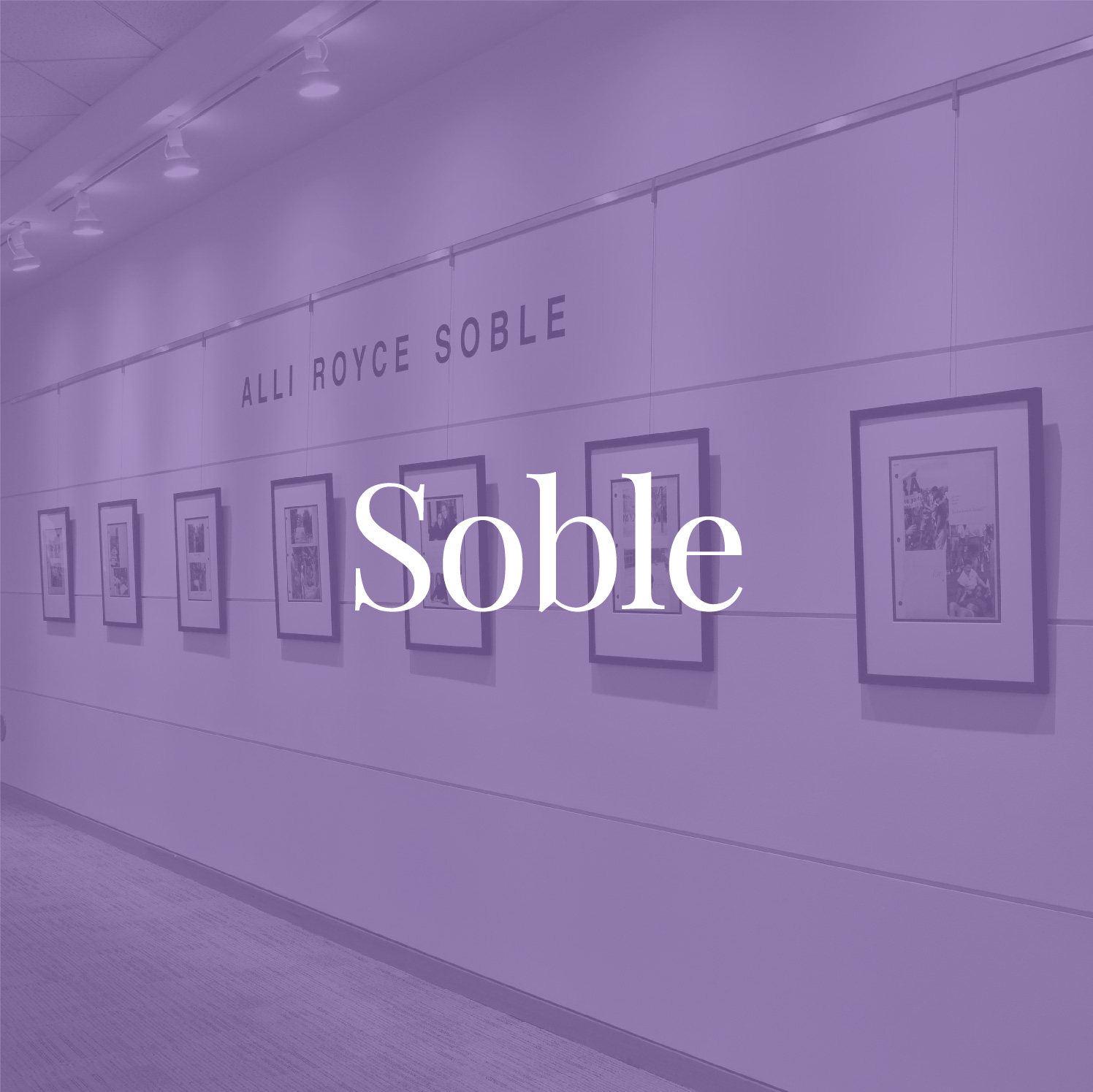 Purple-tinted photograph of Soble's scrapbook pages on display in the corridor of Emory University's Woodruff Library