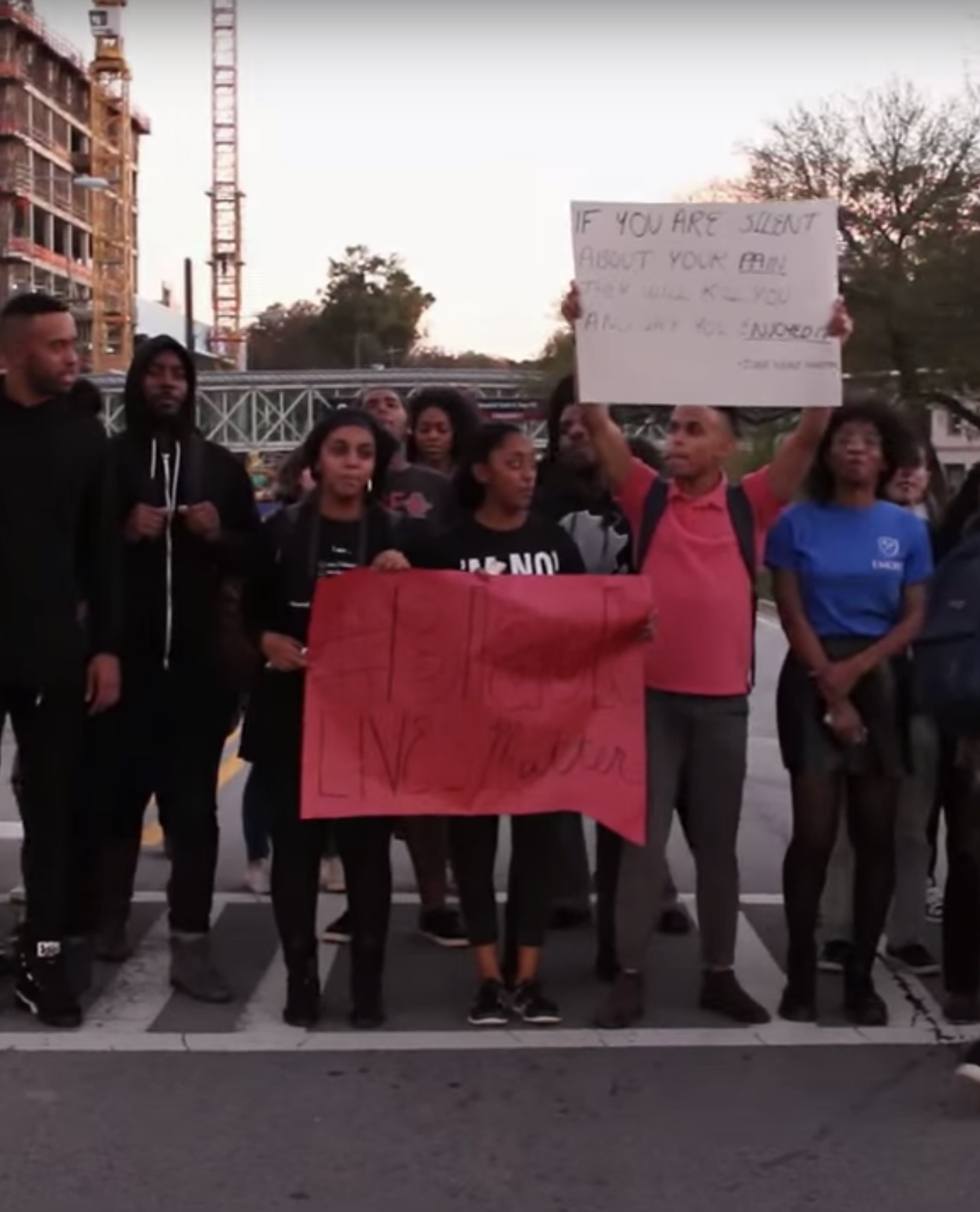 "#Black Lives Matter" sign held by demonstrators