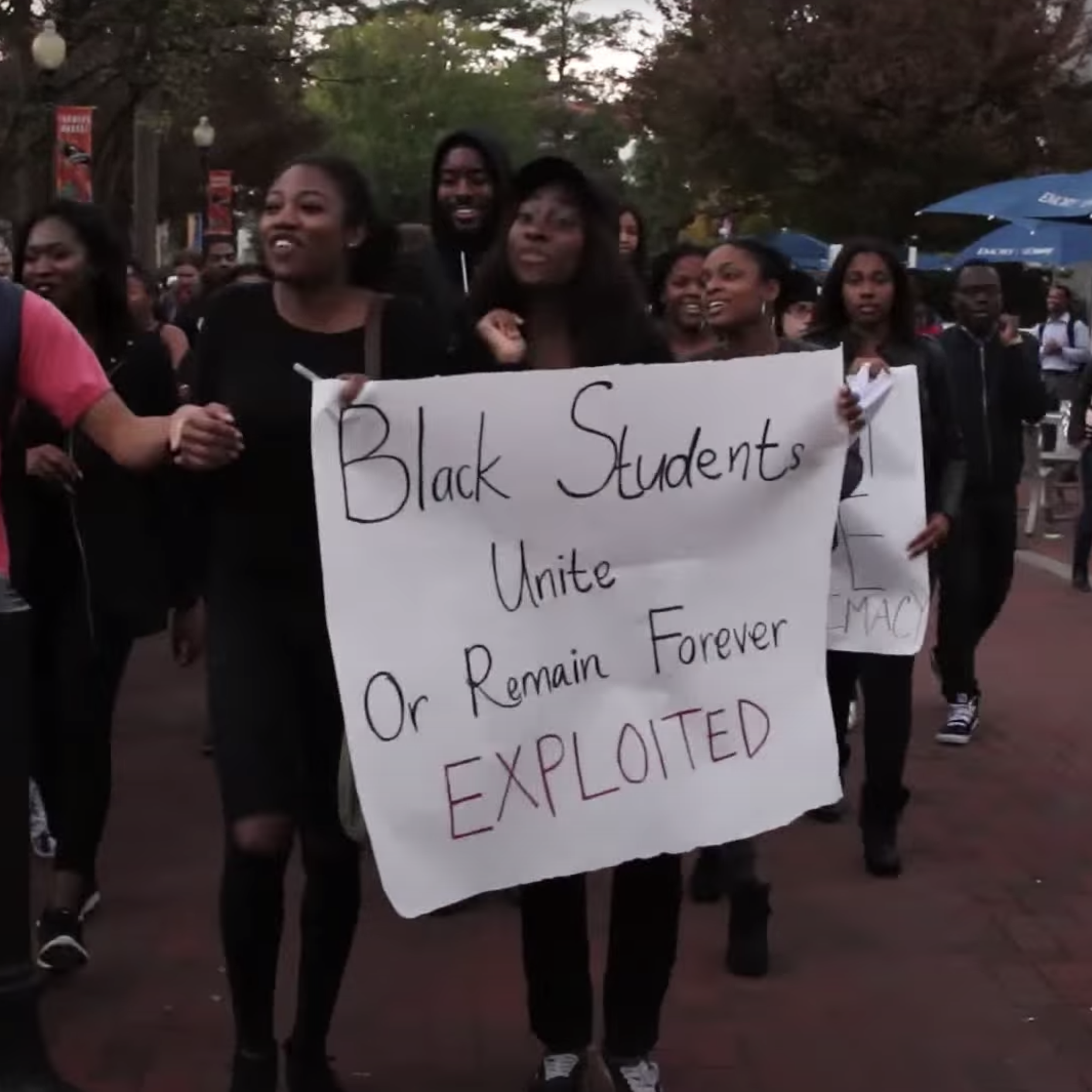 "Black Students Unite Or Remain Forever EXPLOITED" sign held by crowd of Emory demonstrators