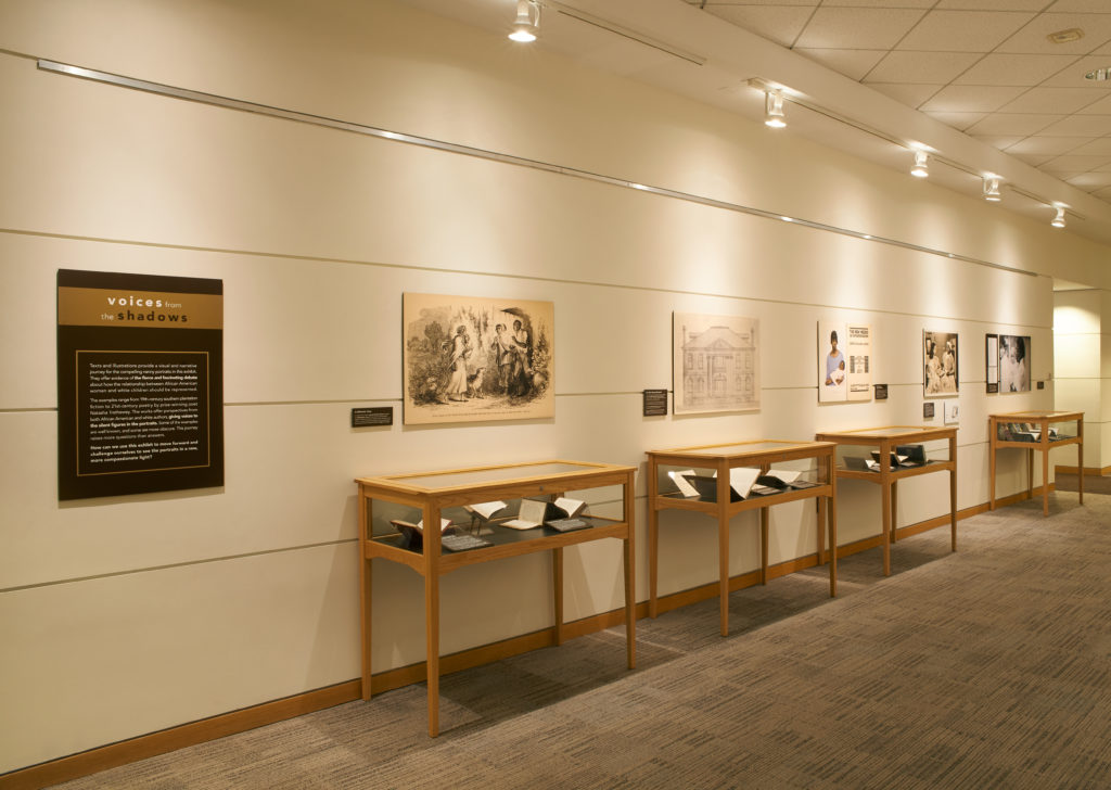 Photograph of exhibit corridor display cases and archival materials