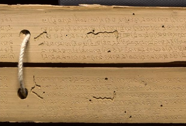 Etched palm leaf pages with insect damage