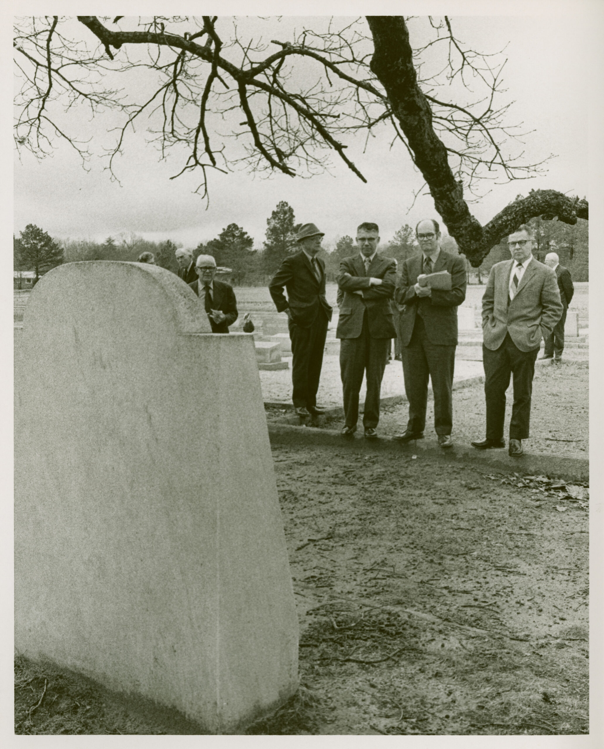 A group of man in front of monument to Catherine Boyd in Oxford Historical Cemetery.